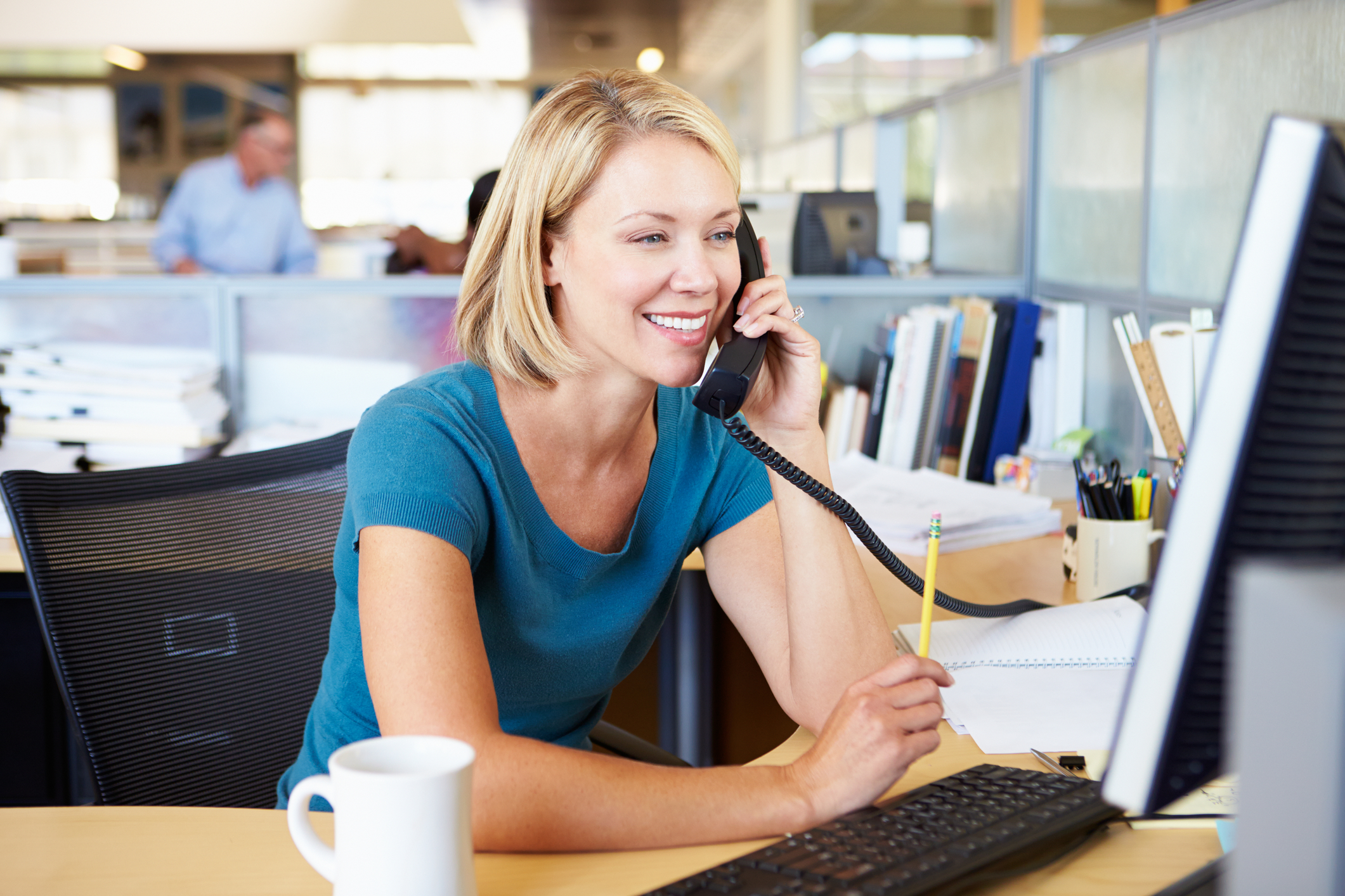 woman-on-phone-in-busy-modern-office-37220533